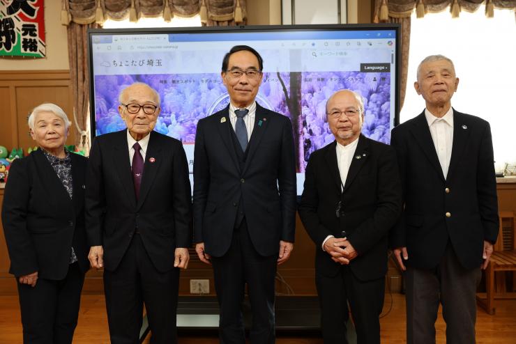 表敬訪問で訪問者と集合写真を撮る知事の写真