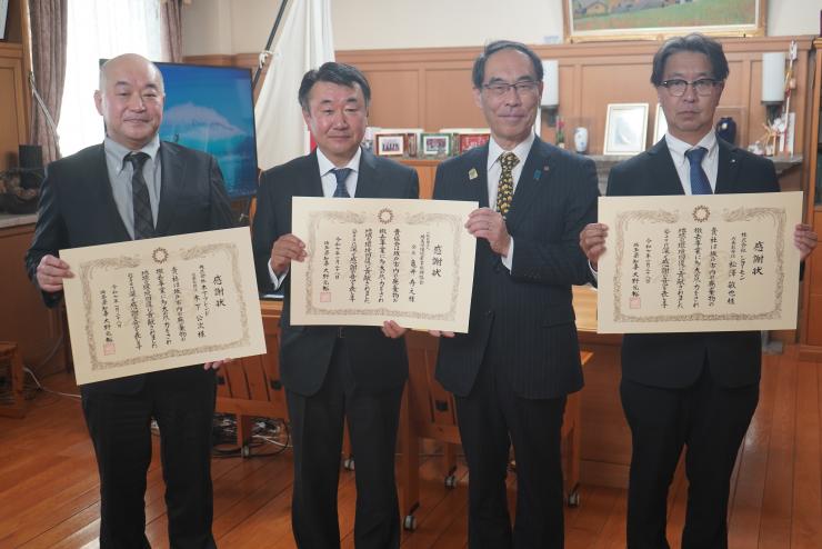 感謝状贈呈式で訪問者と集合写真を撮る知事の写真